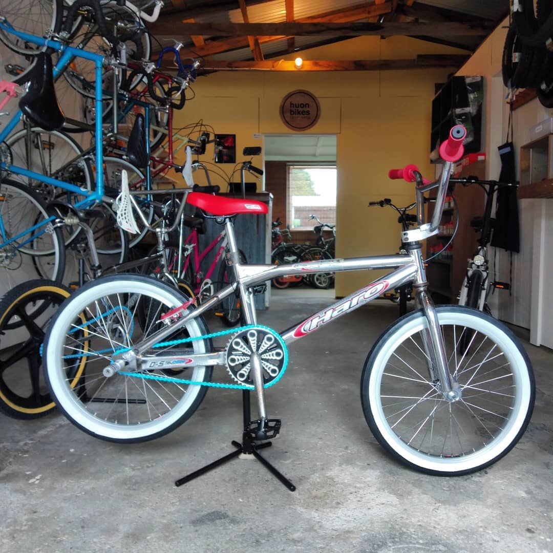 A fully rebuilt chrome Haro BMX on a workstand at Huon Bikes, with white wall tyres